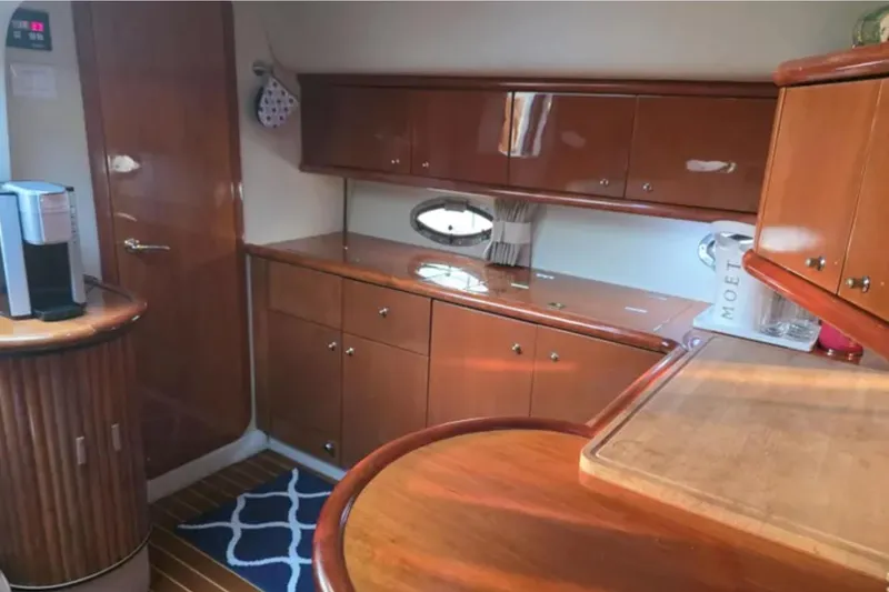 Slide: The Image of Interior of 2001 Sunseeker Camargue 44 yacht with wooden cabinetry and modern amenities. - 11