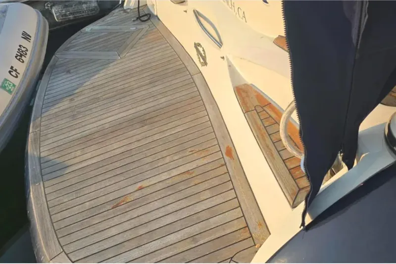 Slide: The Image of 2001 Sunseeker Camargue 44 yacht deck with wooden finish and mooring details. - 7