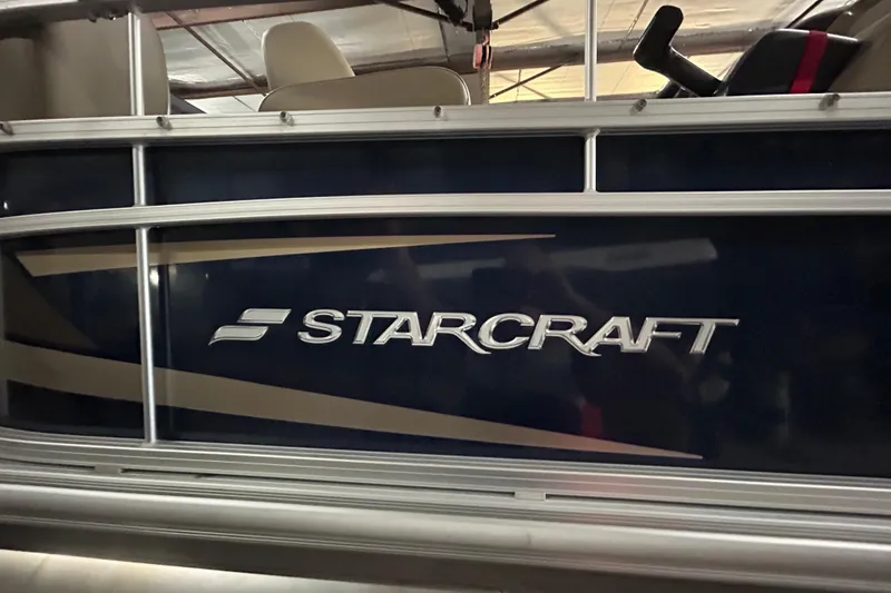 Slide: The Image of 2023 Starcraft LX 18 F boat side view with logo in a showroom. - 15