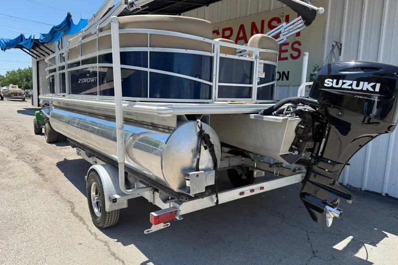 Slide: The Image of 2023 Starcraft LX 18 F pontoon boat with Suzuki outboard motor on trailer. - 20