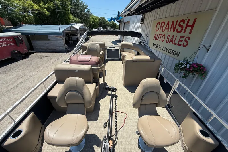 Slide: The Image of 2023 Starcraft LX 18 F pontoon boat at Cransh Auto Sales, featuring beige seating. - 22