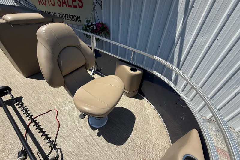 Slide: The Image of 2023 Starcraft LX 18 F boat interior with beige seating and metal railing. - 24