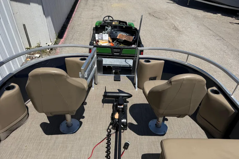 Slide: The Image of 2023 Starcraft LX 18 F boat interior with beige seats and steering console. - 28
