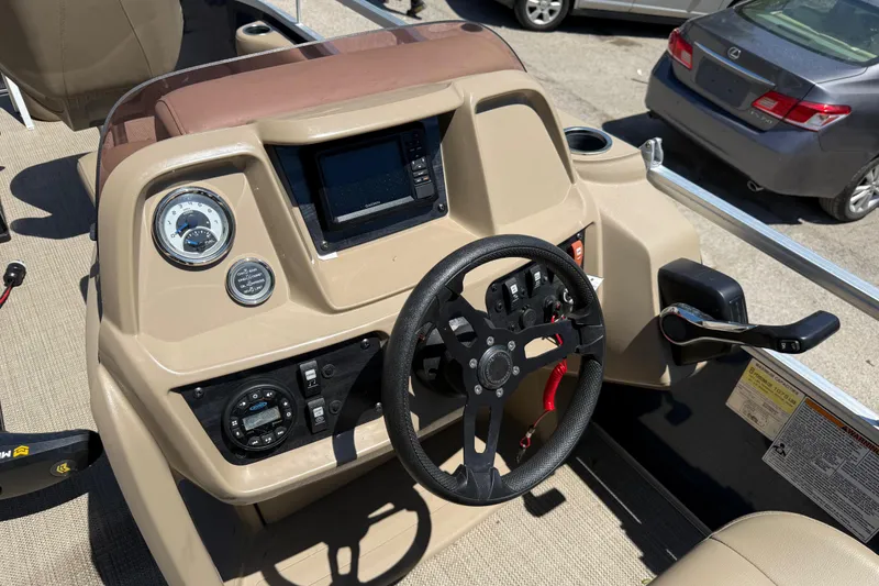 Slide: The Image of 2023 Starcraft LX 18 F boat dashboard with steering wheel and control panel. - 31