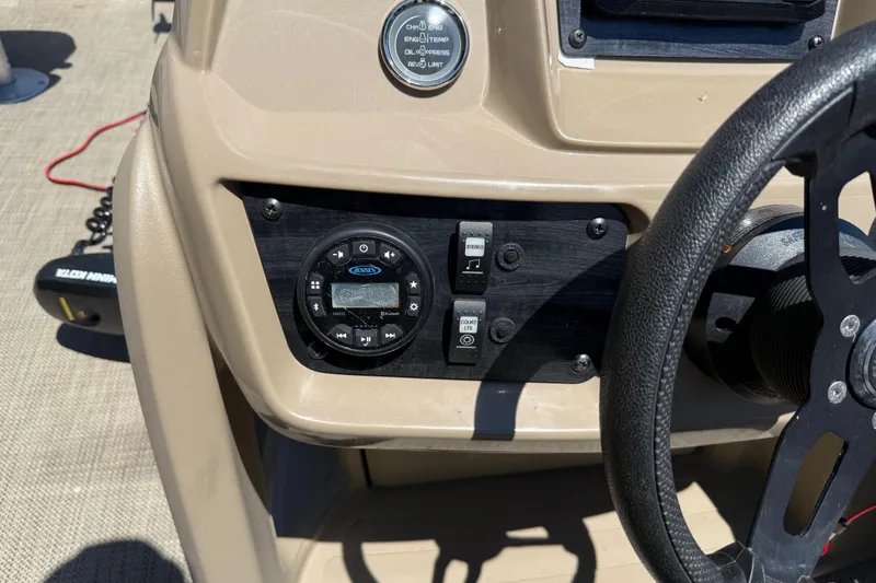 Slide: The Image of Dashboard of 2023 Starcraft LX 18 F boat with steering wheel and control panel. - 32