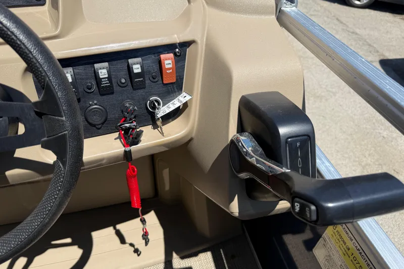 Slide: The Image of Control panel of 2023 Starcraft LX 18 F boat with steering wheel and throttle. - 34
