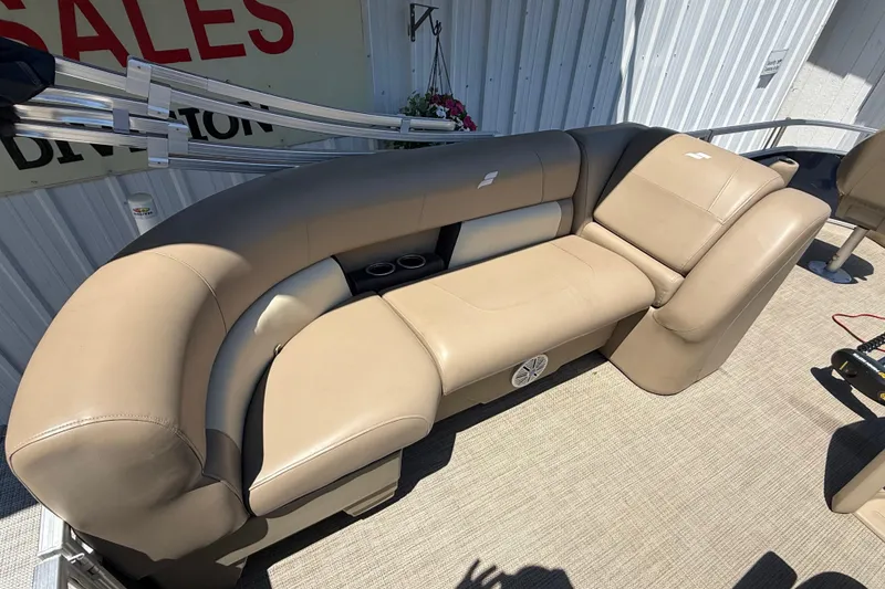 Slide: The Image of Luxurious beige seating on 2023 Starcraft LX 18 F boat, featuring cup holders and speaker. - 35