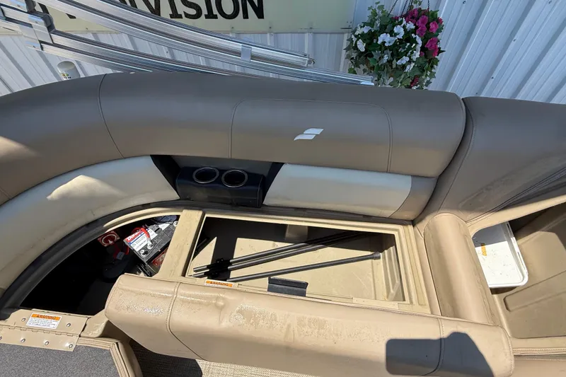 Slide: The Image of 2023 Starcraft LX 18 F boat interior with storage compartment and cup holders. - 38