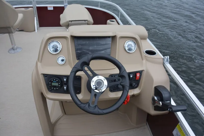 Slide: The Image of Manufacturer Provided Image: 2023 Starcraft LX 18 F boat dashboard with steering wheel and controls. - 48