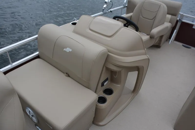 Slide: The Image of Manufacturer Provided Image: 2023 Starcraft LX 18 F boat interior with beige seating and steering console. - 50