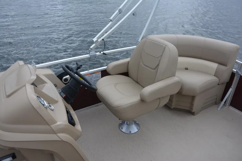 Slide: The Image of Manufacturer Provided Image: 2023 Starcraft LX 18 F boat interior with beige captain's chair and seating. - 6