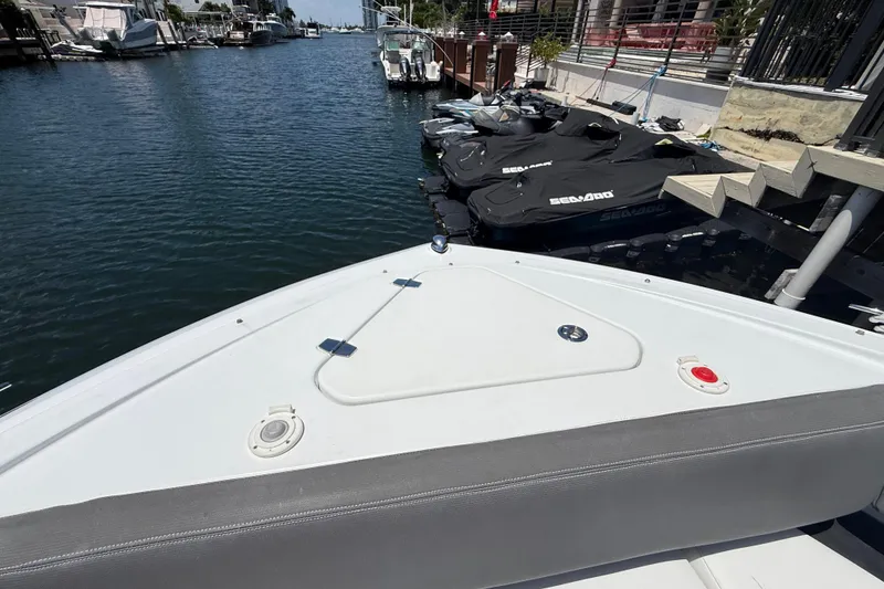 Slide: The Image of 2021 Cruisers Yachts 38 GLS OB docked near jet skis in a marina. - 10
