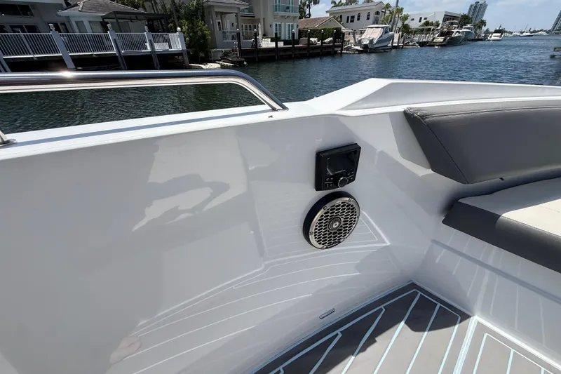 Slide: The Image of 2021 Cruisers Yachts 38 GLS OB interior with speaker and seating, dockside view. - 13