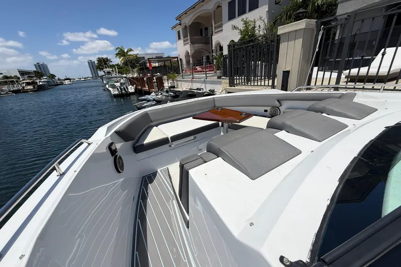 Slide: The Image of 2021 Cruisers Yachts 38 GLS OB, luxury boat docked by waterfront homes. - 14