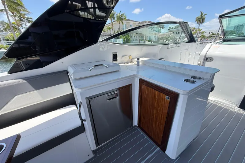 Slide: The Image of 2021 Cruisers Yachts 38 GLS OB boat interior with sleek kitchenette and modern design. - 19