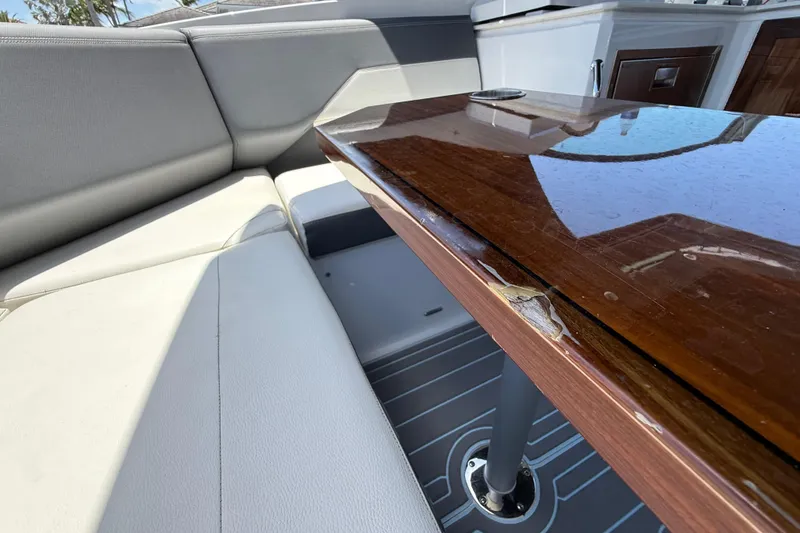 Slide: The Image of Interior seating and table of 2021 Cruisers Yachts 38 GLS OB, featuring sleek design. - 25