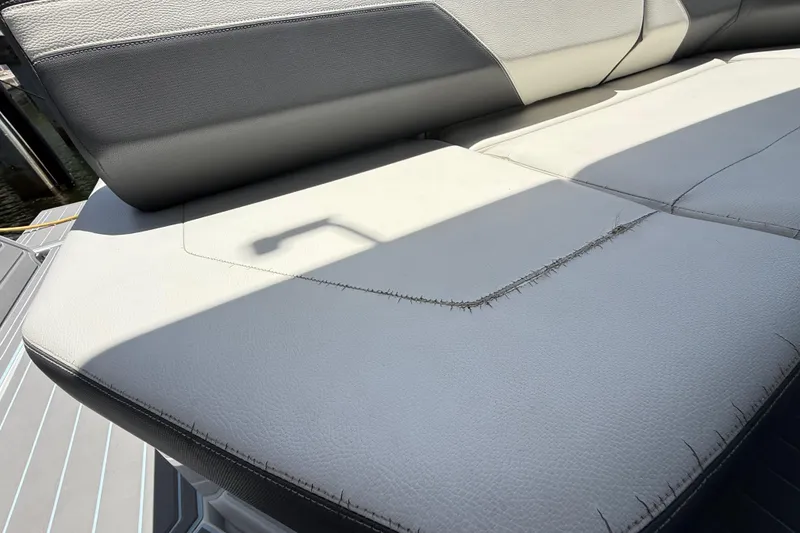 Slide: The Image of Worn seating on 2021 Cruisers Yachts 38 GLS OB, showing visible stitching and sunlight. - 26