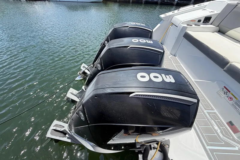 Slide: The Image of Triple outboard motors on a 2021 Cruisers Yachts 38 GLS OB in water. - 34