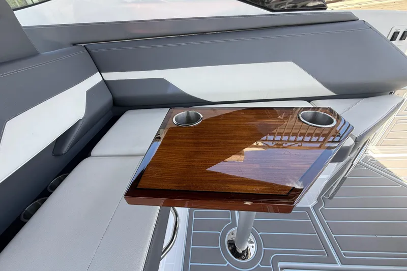 Slide: The Image of Luxury seating area on 2021 Cruisers Yachts 38 GLS OB with sleek wooden table. - 39