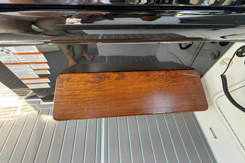 Slide: The Image of 2021 Cruisers Yachts 38 GLS OB interior detail with wood accent and safety labels. - 41