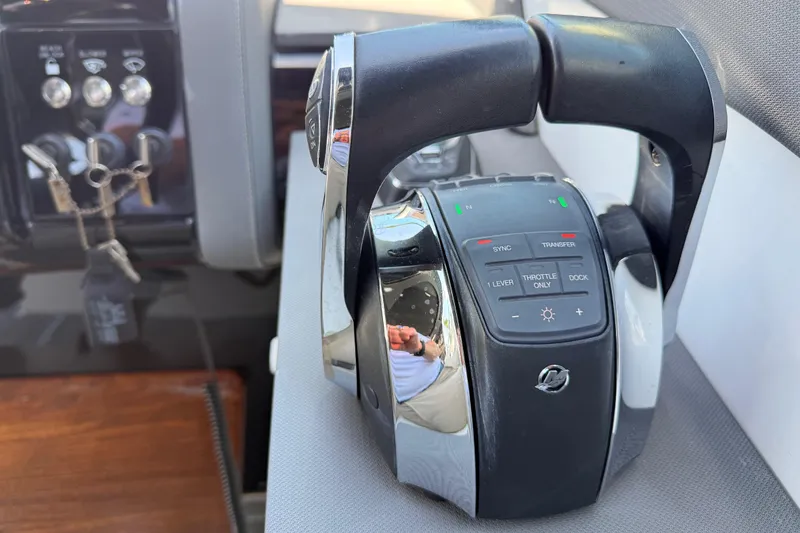Slide: The Image of Throttle controls of a 2021 Cruisers Yachts 38 GLS OB, featuring advanced navigation buttons. - 46
