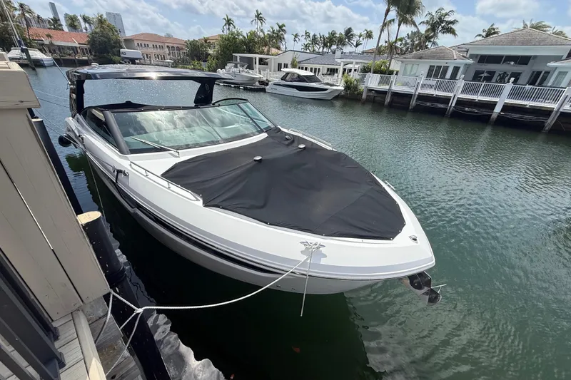Slide: The Image of 2021 Cruisers Yachts 38 GLS OB docked in a scenic waterfront setting. - 5