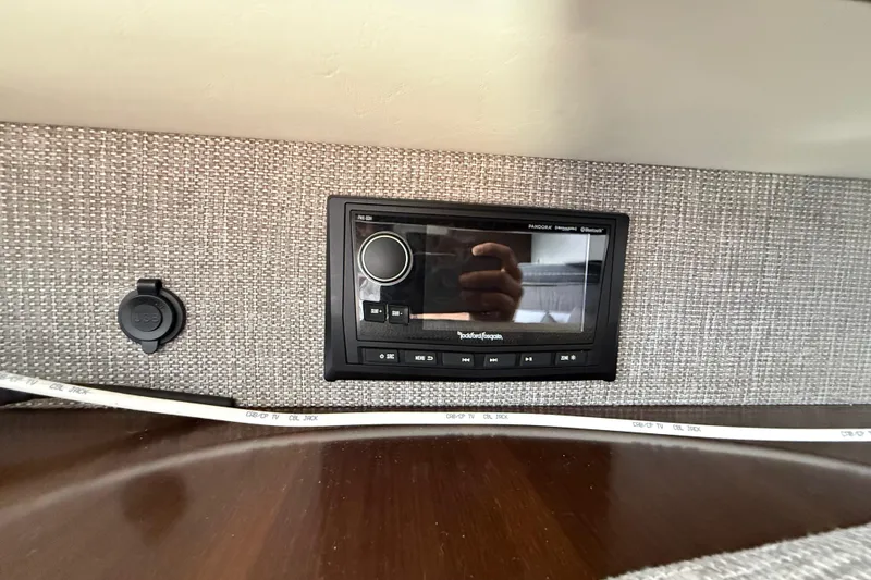 Slide: The Image of 2021 Cruisers Yachts 38 GLS OB interior with Rockford Fosgate stereo system and USB port. - 58