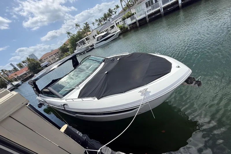 Slide: The Image of 2021 Cruisers Yachts 38 GLS OB docked in a scenic waterfront setting. - 6