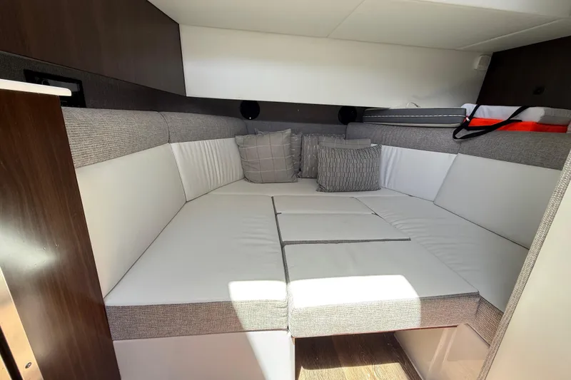 Slide: The Image of Interior cabin of 2021 Cruisers Yachts 38 GLS OB with cushioned seating and pillows. - 61
