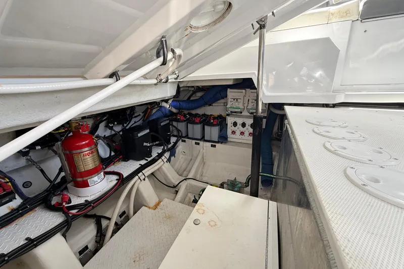 Slide: The Image of Engine compartment of 2021 Cruisers Yachts 38 GLS OB, featuring wiring and fire extinguisher. - 64