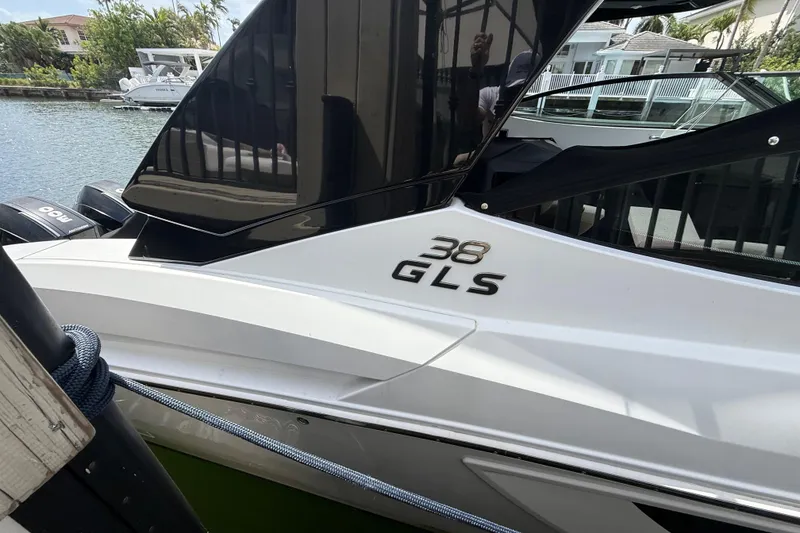 Slide: The Image of 2021 Cruisers Yachts 38 GLS OB docked by waterfront homes. - 8