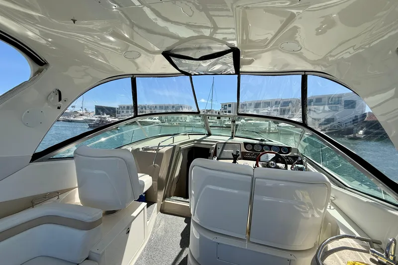 Slide: The Image of Interior view of a 2009 Sea Ray Sundancer 350 yacht, showcasing helm and seating area. - 10