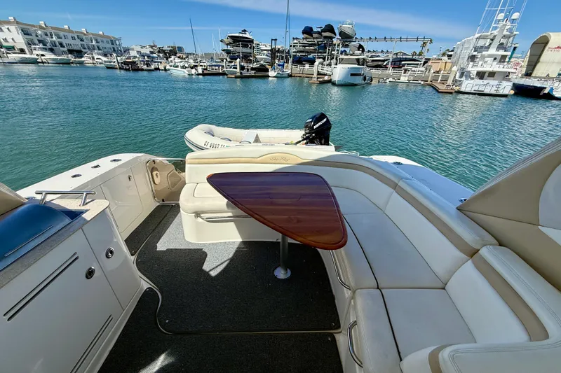 Slide: The Image of 2009 Sea Ray Sundancer 350 yacht interior with seating and table, docked in a marina. - 11