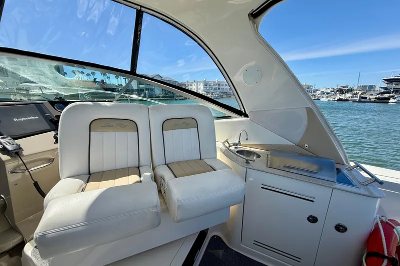 Slide: The Image of Interior view of 2009 Sea Ray Sundancer 350 yacht with helm seats and kitchenette. - 13