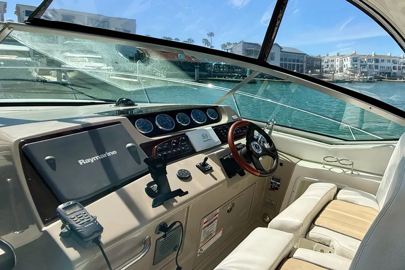 Slide: The Image of Interior view of 2009 Sea Ray Sundancer 350 boat cockpit with steering wheel and navigation equipment. - 14