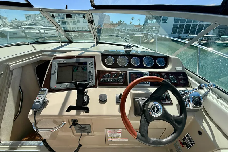 Slide: The Image of 2009 Sea Ray Sundancer 350 helm with navigation controls and steering wheel. - 15