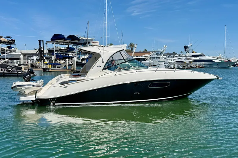 Slide: The Image of 2009 Sea Ray Sundancer 350 yacht docked in marina, clear blue sky background. - 2