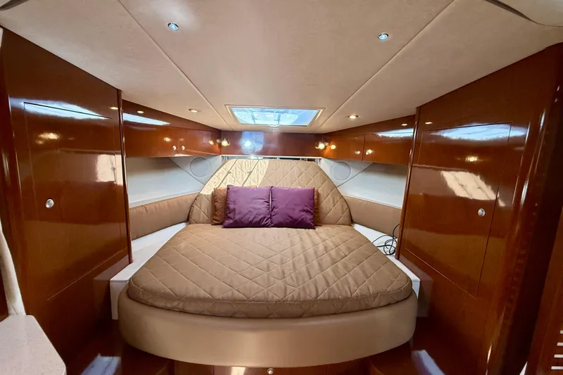 Slide: The Image of Luxurious cabin interior of 2009 Sea Ray Sundancer 350 yacht with plush bedding. - 5