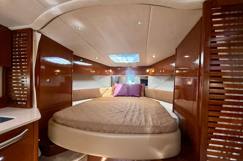 Slide: The Image of Luxurious interior of 2009 Sea Ray Sundancer 350 yacht with cozy bed and elegant wood finish. - 6
