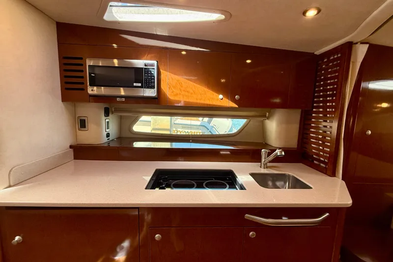 Slide: The Image of Luxurious 2009 Sea Ray Sundancer 350 yacht kitchen with modern amenities and sleek design. - 8