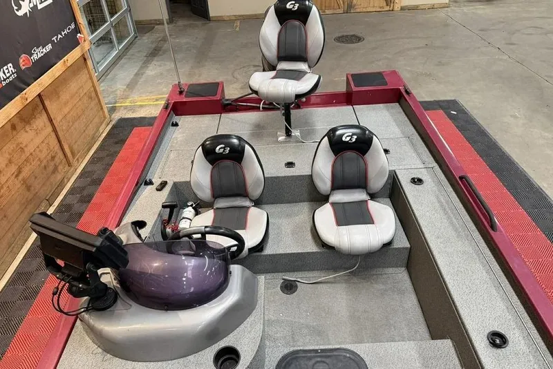 Slide: The Image of 2015 G3 Eagle 176 boat interior with three seats and steering console. - 3