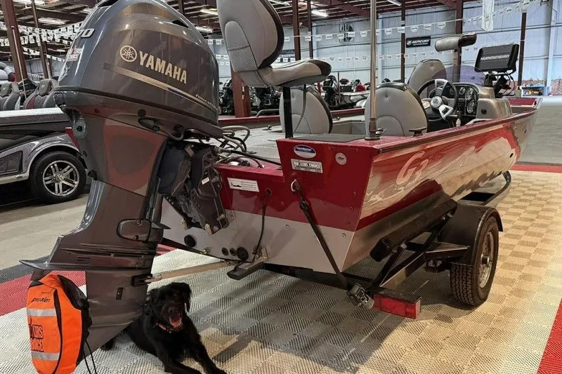 Slide: The Image of 2015 G3 Eagle 176 boat with Yamaha motor in showroom, accompanied by a black dog. - 5