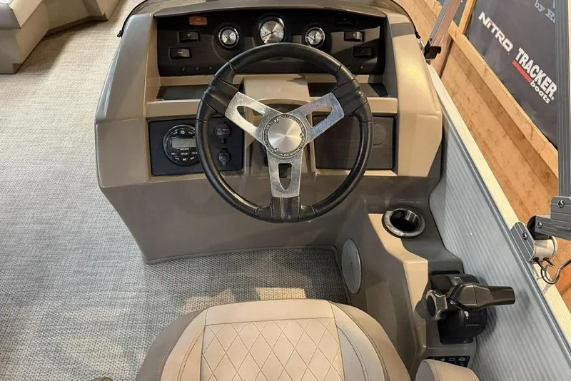 Slide: The Image of 2019 Bennington 22 SSBXP boat helm with steering wheel and control panel. - 10