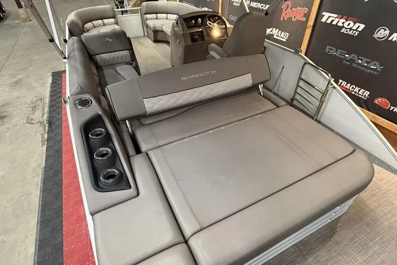 Slide: The Image of 2019 Bennington 22 SSBXP pontoon boat interior with plush seating and cup holders. - 4