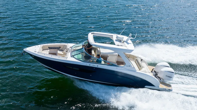 The Image of 2019 Regal 33 OBX boat cruising on open water, showcasing sleek design and powerful engines. - 0