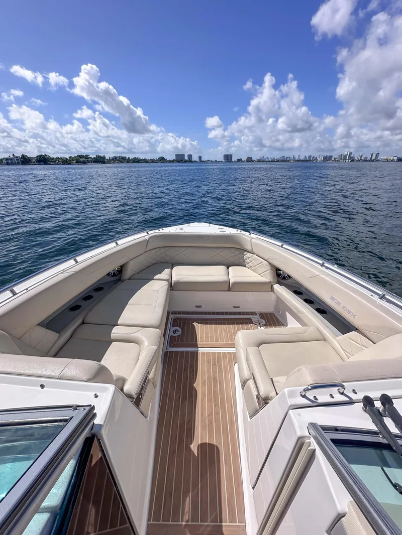 Slide: The Image of 2019 Regal 33 OBX boat with spacious seating, cruising on a sunny day. - 22