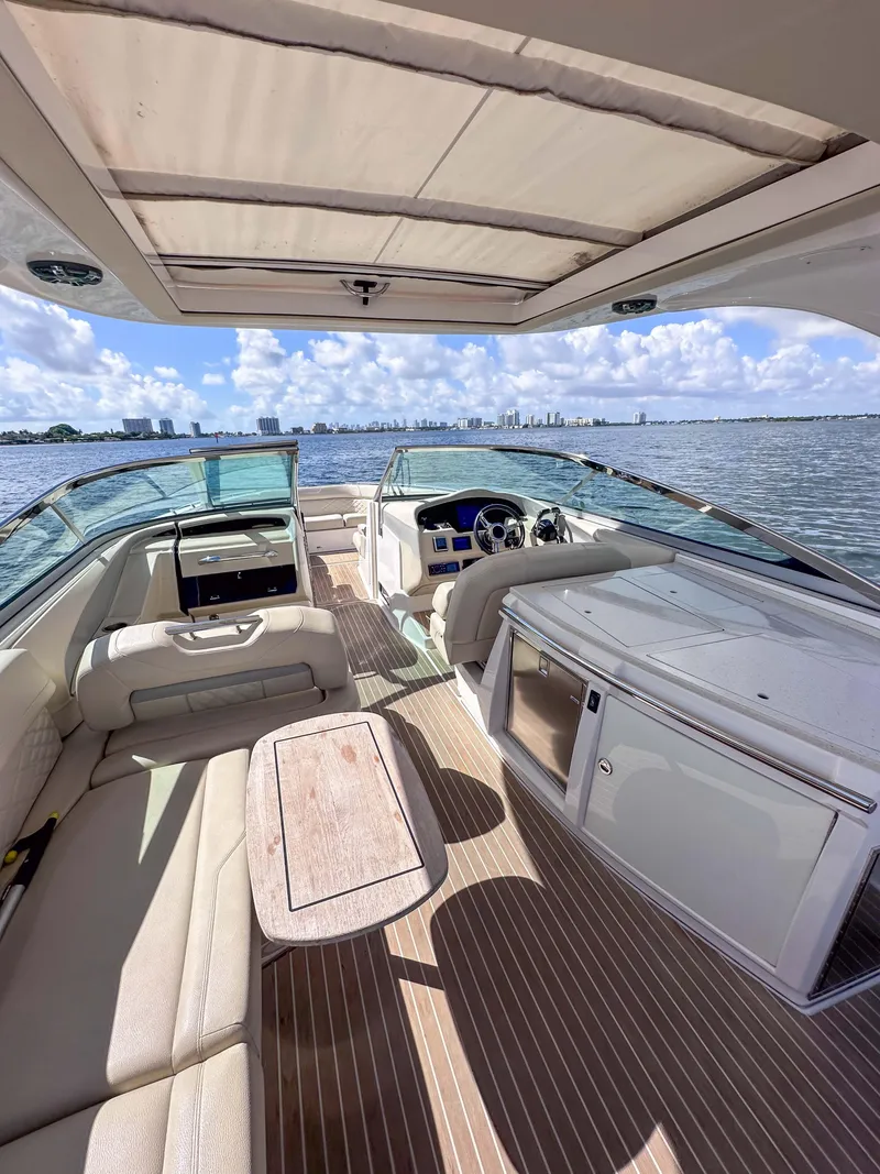 Slide: The Image of 2019 Regal 33 OBX boat interior with spacious seating and modern amenities on open water. - 29