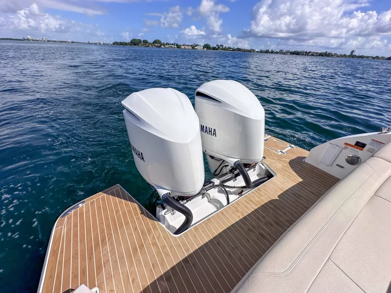 Slide: The Image of 2019 Regal 33 OBX boat with twin Yamaha outboard engines on a sunny day. - 34