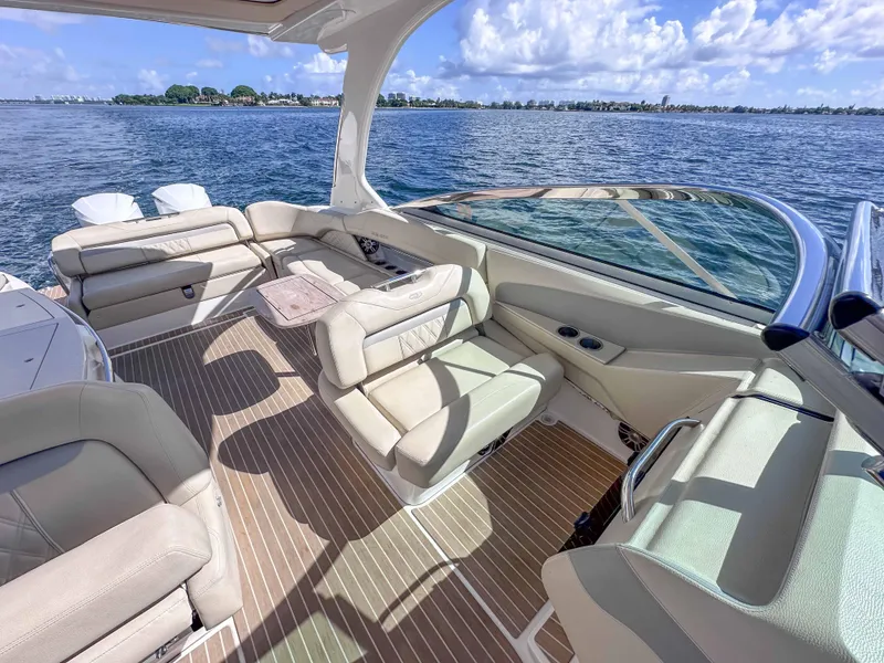 Slide: The Image of Luxurious 2019 Regal 33 OBX boat interior with beige seating and scenic ocean view. - 38