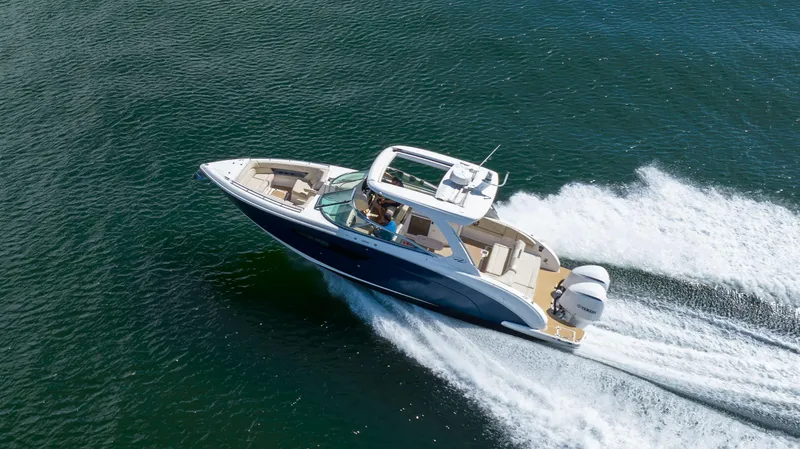 Slide: The Image of 2019 Regal 33 OBX boat cruising swiftly on open water. - 4